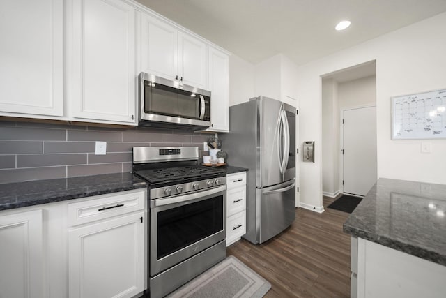 136 Bigelow Dr, Johnstown, OH 43031 - kitchen featuring stainless steel appliances, white cabinets, tasteful backsplash, dark wood-style floors, and dark stone counters