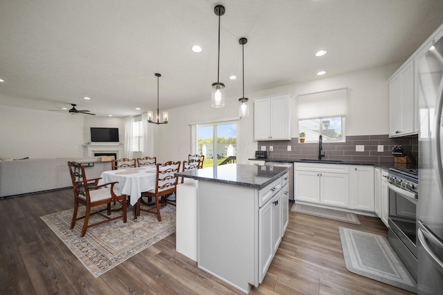 136 Bigelow Dr, Johnstown, OH 43031 - kitchen with a sink, stainless steel appliances, open floor plan, backsplash, and a kitchen island
