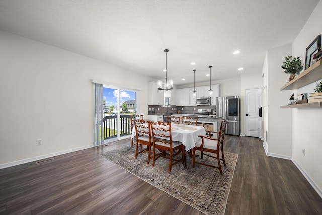 136 Bigelow Dr, Johnstown, OH 43031 - dining room with a chandelier, recessed lighting, dark wood-style flooring, and baseboards