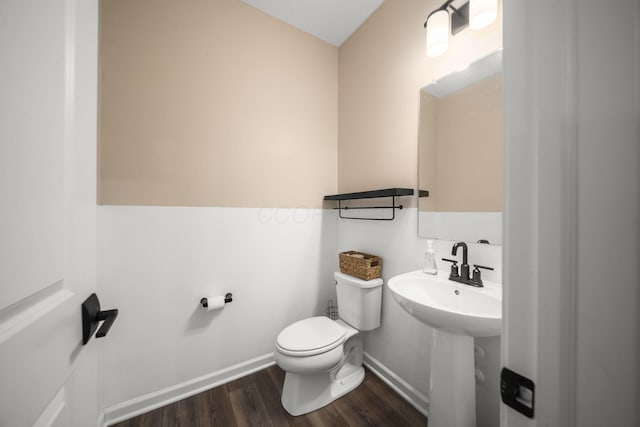 136 Bigelow Dr, Johnstown, OH 43031 - half bathroom featuring wood finished floors, toilet, baseboards, and a sink