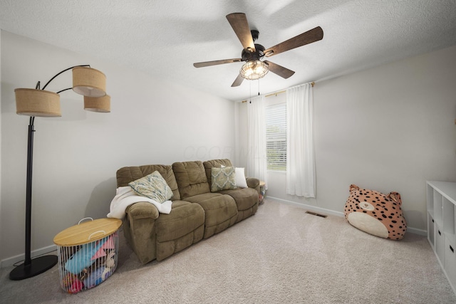 136 Bigelow Dr, Johnstown, OH 43031 - living area with ceiling fan, carpet floors, baseboards, and a textured ceiling