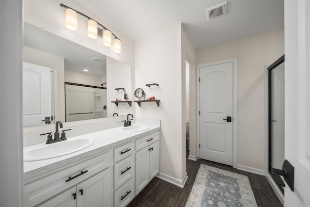 136 Bigelow Dr, Johnstown, OH 43031 - full bathroom with a stall shower, wood finished floors, double vanity, and baseboards
