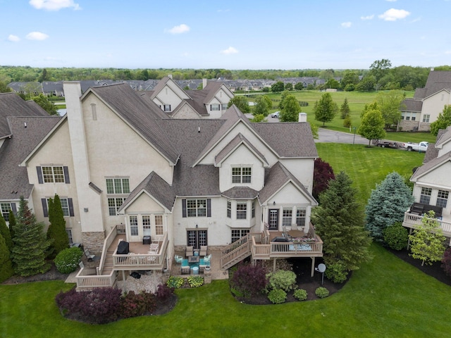 6755 Arbor View Ct, Powell, OH 43065 - rear view of house featuring stucco siding, a wooden deck, a shingled roof, a chimney, and a lawn