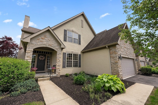 6755 Arbor View Ct, Powell, OH 43065 - view of front of property with stone siding, stucco siding, a chimney, and driveway