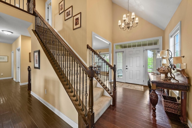 6755 Arbor View Ct, Powell, OH 43065 - entrance foyer featuring high vaulted ceiling, baseboards, wood finished floors, stairs, and a chandelier