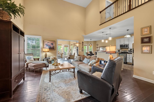 6755 Arbor View Ct, Powell, OH 43065 - living area with a high ceiling, dark wood finished floors, and baseboards