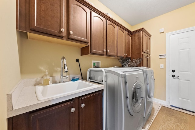 6755 Arbor View Ct, Powell, OH 43065 - laundry area featuring washing machine and dryer, cabinet space, and light tile patterned flooring
