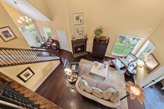 6755 Arbor View Ct, Powell, OH 43065 - living area with a towering ceiling, a chandelier, hardwood / wood-style flooring, a fireplace, and baseboards