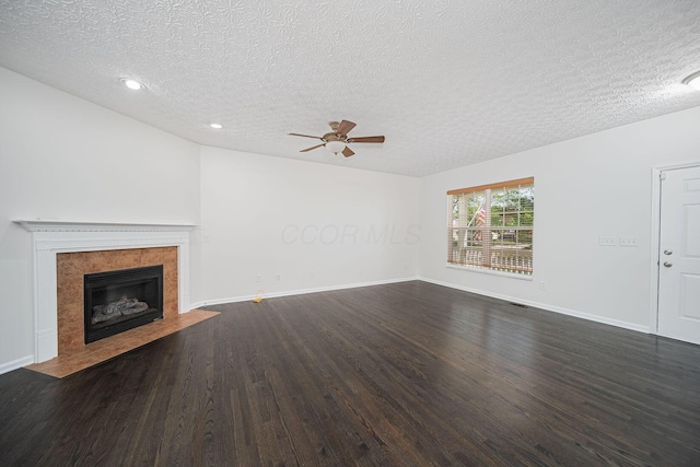 1019 Wallace Dr, Delaware, OH 43015 - unfurnished living room featuring a textured ceiling, ceiling fan, wood finished floors, a tiled fireplace, and recessed lighting
