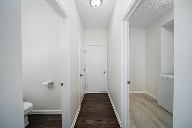 1019 Wallace Dr, Delaware, OH 43015 - hallway with wood finished floors, a textured ceiling, and baseboards