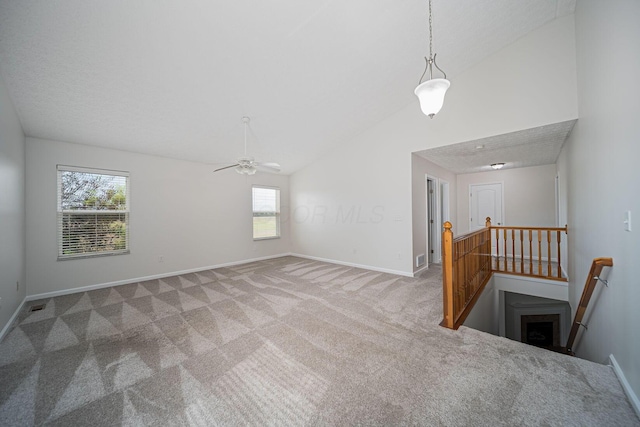 1019 Wallace Dr, Delaware, OH 43015 - unfurnished living room featuring lofted ceiling, baseboards, carpet flooring, and a ceiling fan
