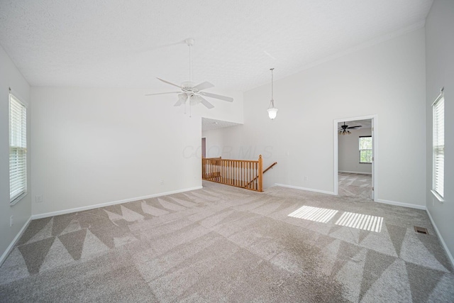 1019 Wallace Dr, Delaware, OH 43015 - empty room featuring carpet floors, ceiling fan, baseboards, and high vaulted ceiling