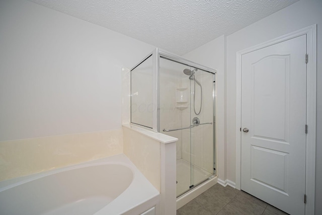 1019 Wallace Dr, Delaware, OH 43015 - bathroom with a shower stall, tile patterned flooring, a garden tub, and a textured ceiling