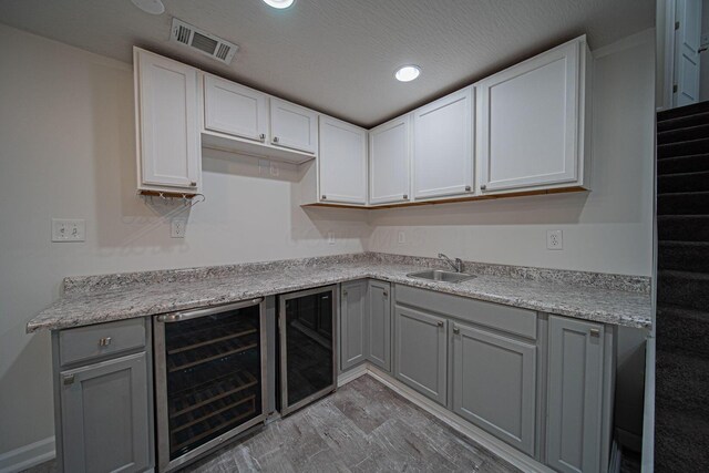 1019 Wallace Dr, Delaware, OH 43015 - kitchen featuring beverage cooler, a sink, gray cabinets, light countertops, and recessed lighting
