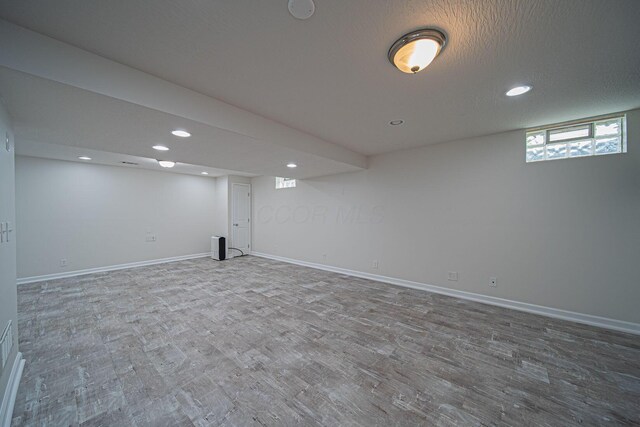 1019 Wallace Dr, Delaware, OH 43015 - below grade area with wood finished floors, recessed lighting, and baseboards