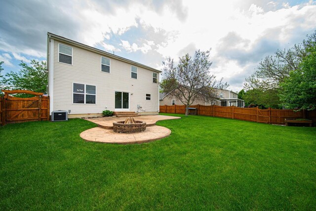 1019 Wallace Dr, Delaware, OH 43015 - back of property featuring a fire pit, cooling unit, and a patio