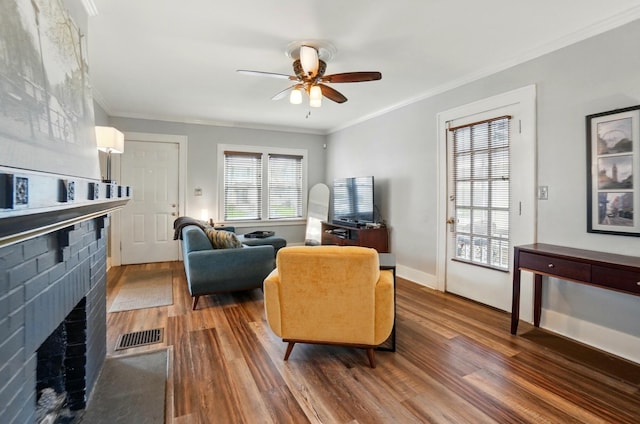 114 Roosevelt Dr, Springfield, OH 45504 - living area featuring wood finished floors, ceiling fan, ornamental molding, a brick fireplace, and baseboards