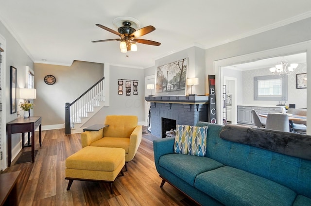 114 Roosevelt Dr, Springfield, OH 45504 - living room with wood finished floors, stairs, a brick fireplace, a chandelier, and a ceiling fan