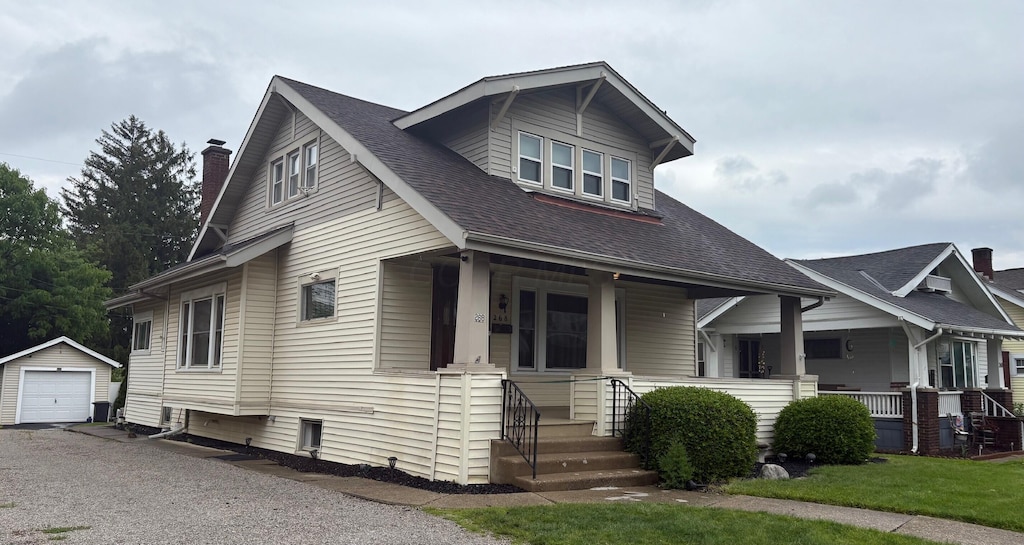 268 Thew Ave, Marion, OH 43302 - bungalow-style house with an outbuilding, covered porch, a garage, a shingled roof, and a chimney
