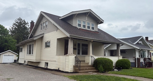 268 Thew Ave, Marion, OH 43302 - bungalow-style house with an outbuilding, covered porch, a garage, a shingled roof, and a chimney