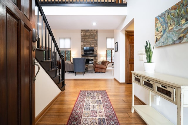 5754 N Loch Maree Ct N, Dublin, OH 43017 - entryway with light wood-style flooring, stairway, a fireplace, baseboards, and recessed lighting