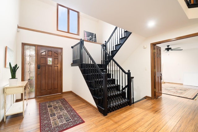 5754 N Loch Maree Ct N, Dublin, OH 43017 - entryway featuring light wood-style flooring, stairway, a ceiling fan, and baseboards