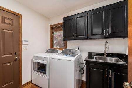 5754 N Loch Maree Ct N, Dublin, OH 43017 - laundry room with washer and dryer, cabinet space, light wood-style flooring, and baseboards
