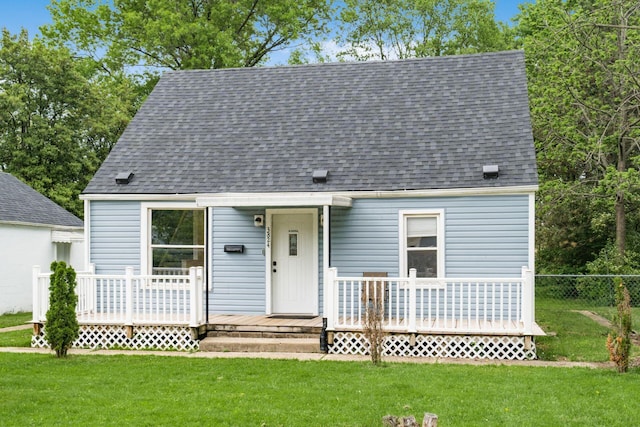 cape cod-style house with a wooden deck and roof with shingles