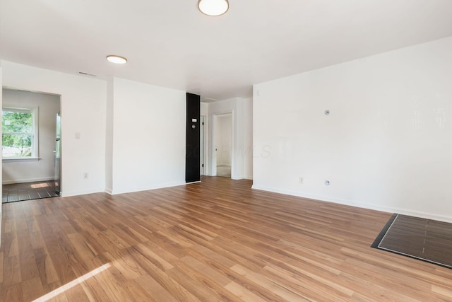 unfurnished room featuring light wood-style floors and baseboards