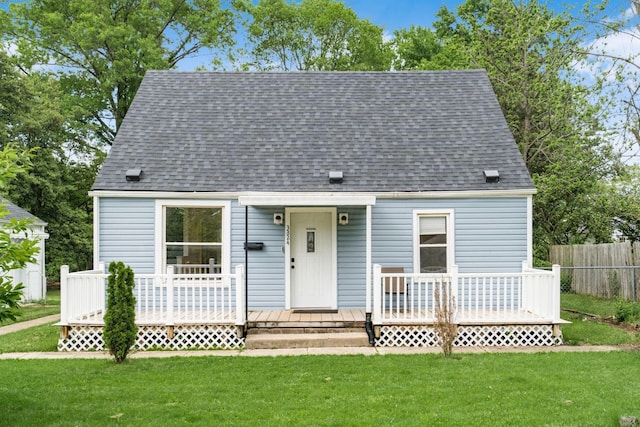 cape cod house with roof with shingles and a wooden deck