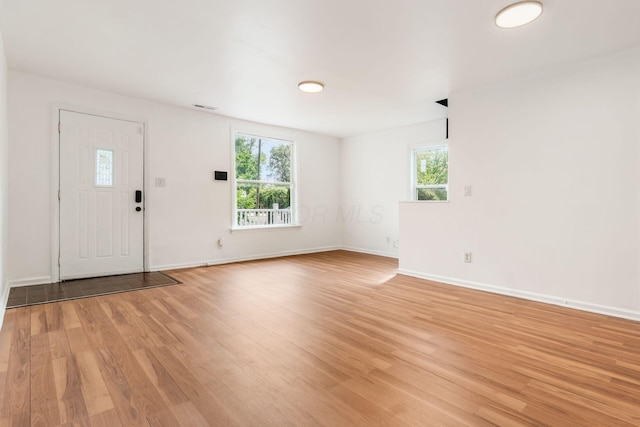 entrance foyer with light wood-type flooring and baseboards