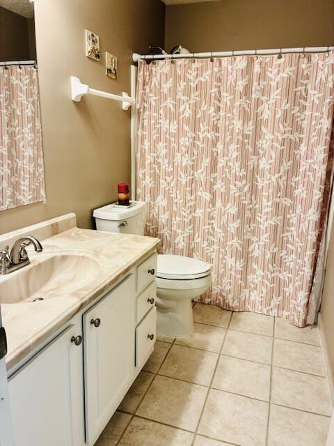 bathroom with toilet, tile patterned flooring, vanity, and a shower with curtain