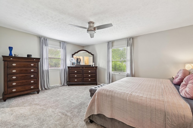 499 Wickham Way, Columbus, OH 43230 - bedroom featuring multiple windows, carpet flooring, a textured ceiling, ceiling fan, and baseboards