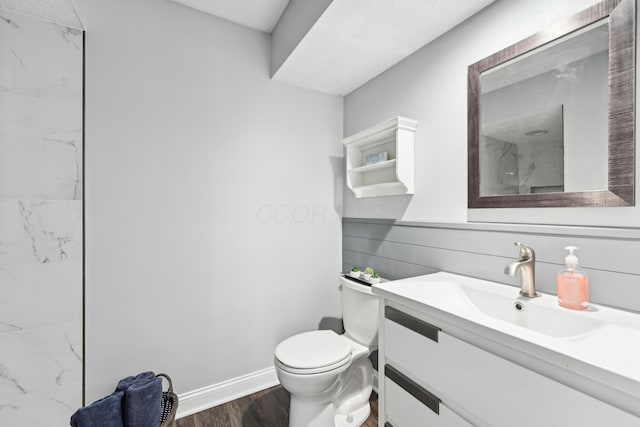 499 Wickham Way, Columbus, OH 43230 - bathroom with wood finished floors, toilet, vanity, baseboards, and a marble finish shower
