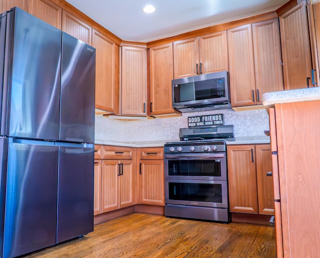 163 E 3rd Ave, Columbus, OH 43201 - kitchen with appliances with stainless steel finishes, light countertops, tasteful backsplash, and recessed lighting