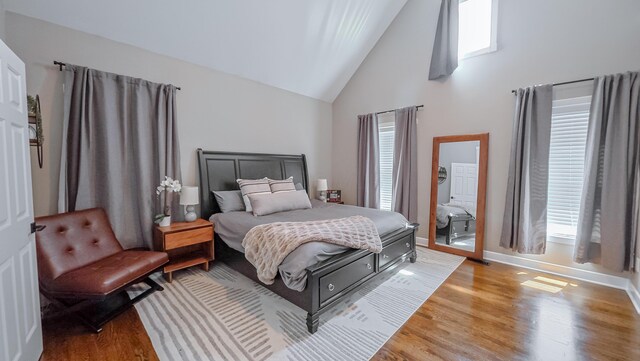 163 E 3rd Ave, Columbus, OH 43201 - bedroom with high vaulted ceiling, light wood-style floors, and baseboards