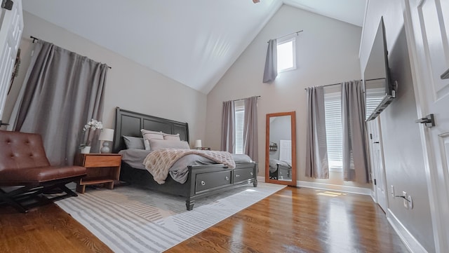 163 E 3rd Ave, Columbus, OH 43201 - bedroom featuring high vaulted ceiling, wood finished floors, and baseboards