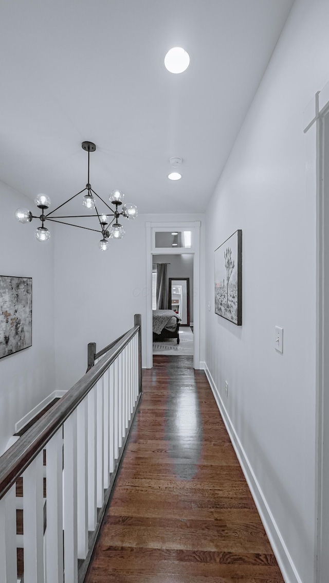 163 E 3rd Ave, Columbus, OH 43201 - corridor featuring a chandelier, dark wood finished floors, baseboards, and an upstairs landing