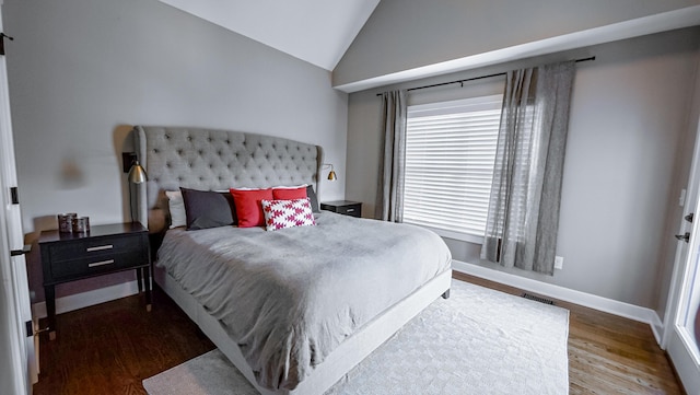 163 E 3rd Ave, Columbus, OH 43201 - bedroom featuring wood finished floors, lofted ceiling, and baseboards