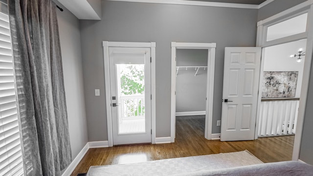 163 E 3rd Ave, Columbus, OH 43201 - unfurnished bedroom with wood finished floors, a spacious closet, baseboards, and a closet