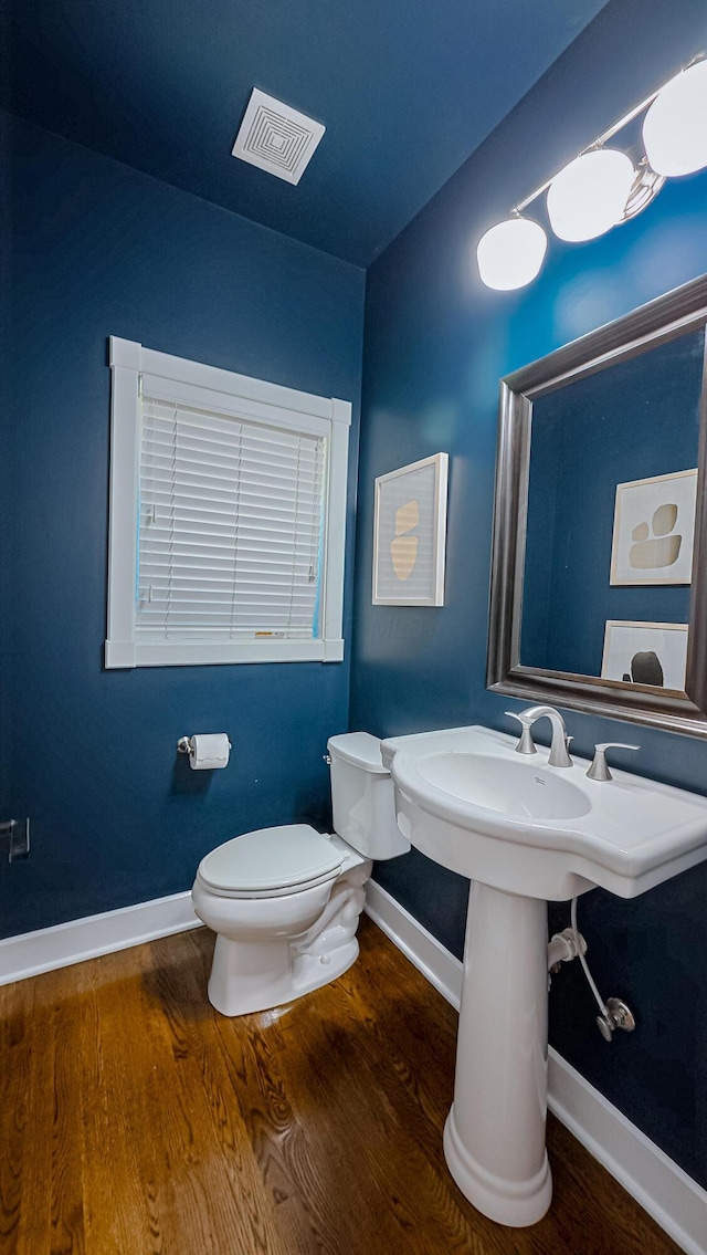 163 E 3rd Ave, Columbus, OH 43201 - bathroom featuring baseboards, wood finished floors, and toilet