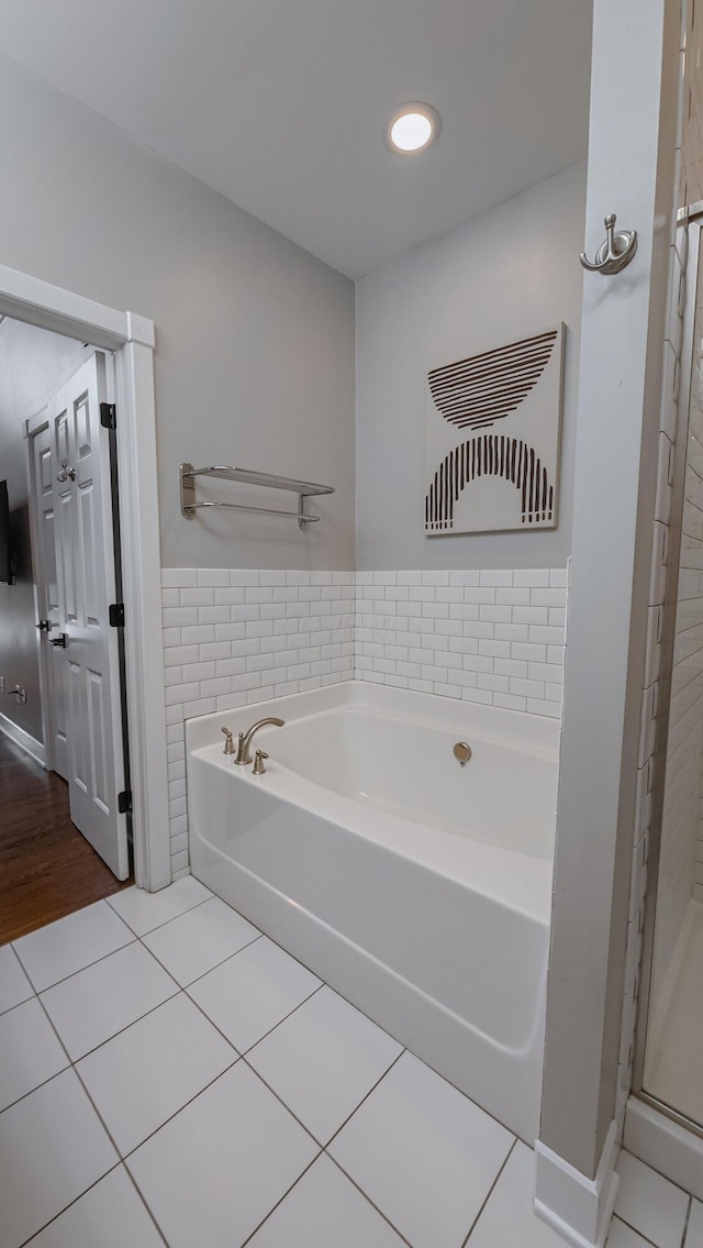 163 E 3rd Ave, Columbus, OH 43201 - bathroom featuring tile patterned flooring, a garden tub, tile walls, and recessed lighting