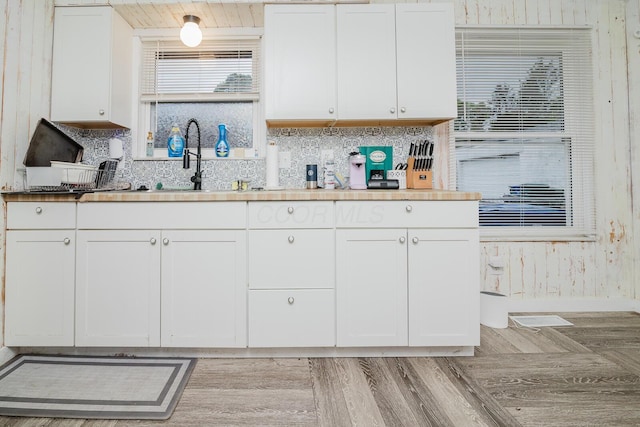 780 Basswood Rd, Columbus, OH 43207 - kitchen featuring decorative backsplash, white cabinetry, and a sink