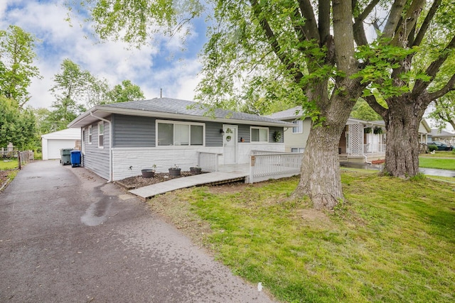 780 Basswood Rd, Columbus, OH 43207 - view of front of home with an outbuilding, a garage, roof with shingles, and a front yard