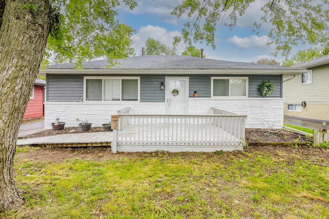 780 Basswood Rd, Columbus, OH 43207 - view of front of property with a deck, a front lawn, stone siding, and a shingled roof
