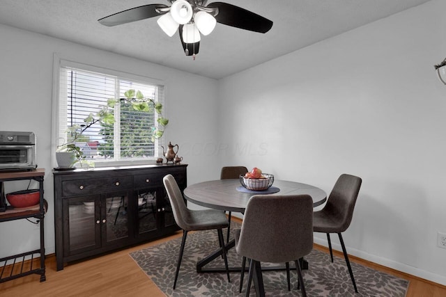 5756 Saffron Ave, Galloway, OH 43119 - dining room featuring light wood-style floors, ceiling fan, and baseboards
