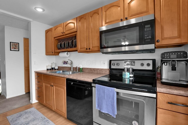 5756 Saffron Ave, Galloway, OH 43119 - kitchen featuring appliances with stainless steel finishes, a sink, light wood-style flooring, and baseboards