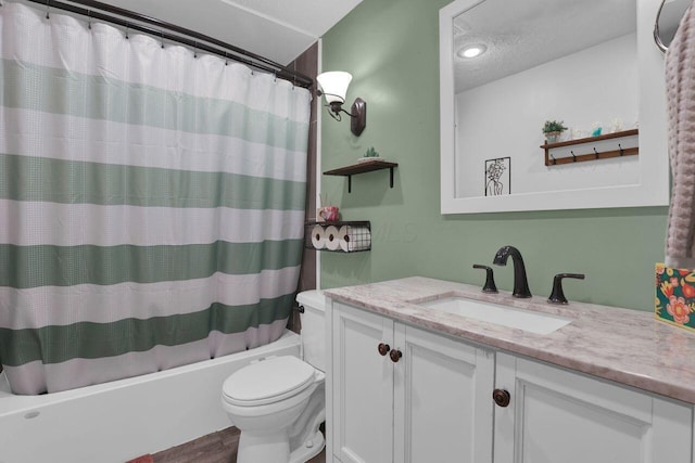 5756 Saffron Ave, Galloway, OH 43119 - bathroom with toilet, shower / bath combo, vanity, wood finished floors, and a textured ceiling