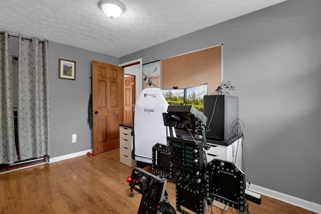 5756 Saffron Ave, Galloway, OH 43119 - exercise area featuring baseboards, wood finished floors, and a textured ceiling