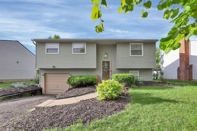 5756 Saffron Ave, Galloway, OH 43119 - raised ranch with an attached garage, gravel driveway, and a front yard